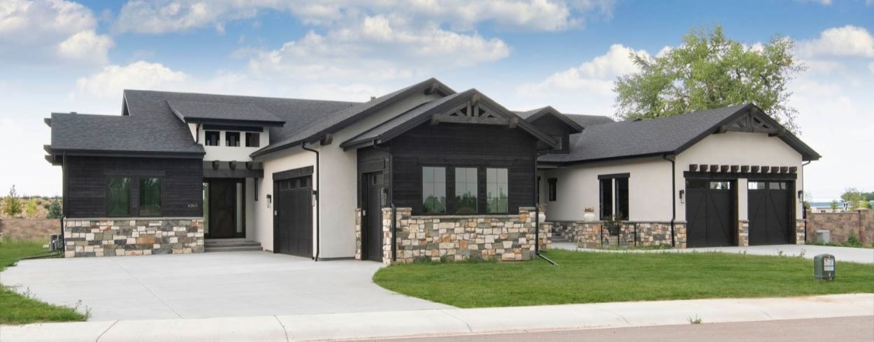 Mixed siding materials featuring AquaFir™ black wood and stucco