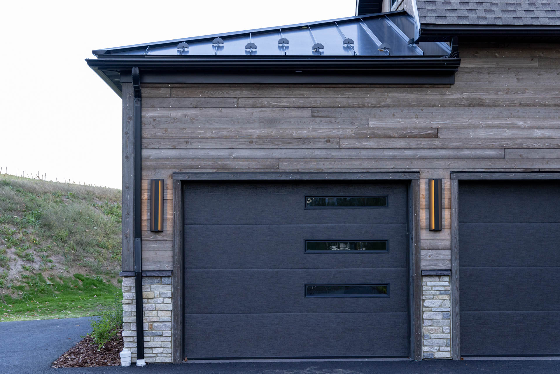 Garage Door Black Accent Details against ranchwood Artisan siding