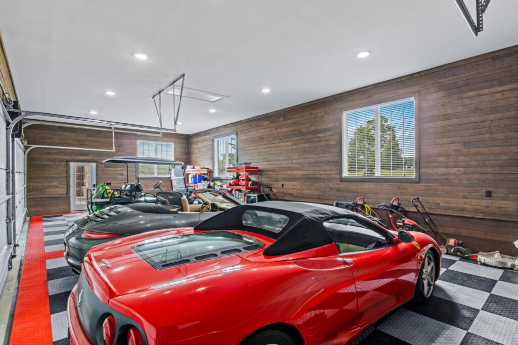 red-ferrari-garage-with-ranchwood-eastern-cedar-siding A red Ferrari parked in a luxury garage featuring continuous ranchwood Eastern cedar siding on the interior walls.