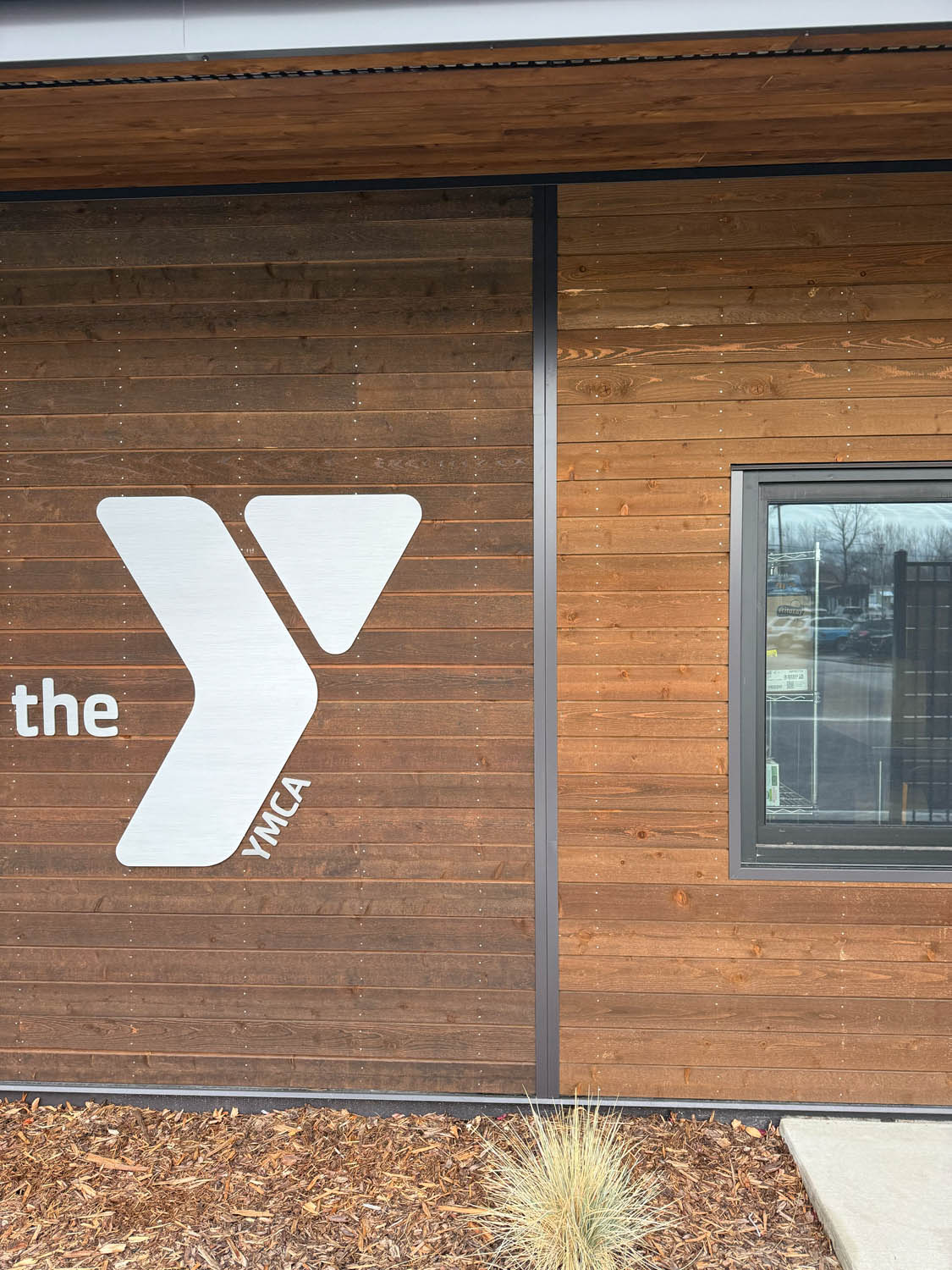 featuring ranchwood Tackroom and AquaFir Brown cedar siding at The Y