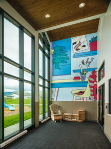 Showing the warm grain of prefinished smooth AquaFir Brown cedar tongue and groove ceiling planks in a childcare facility.