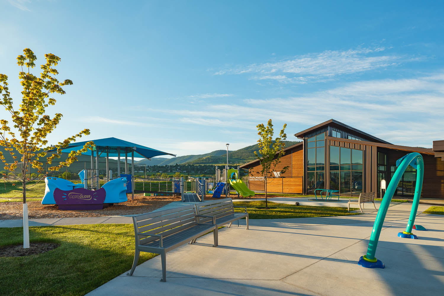 Showing playground at the Y with Cedar Siding with sunshine