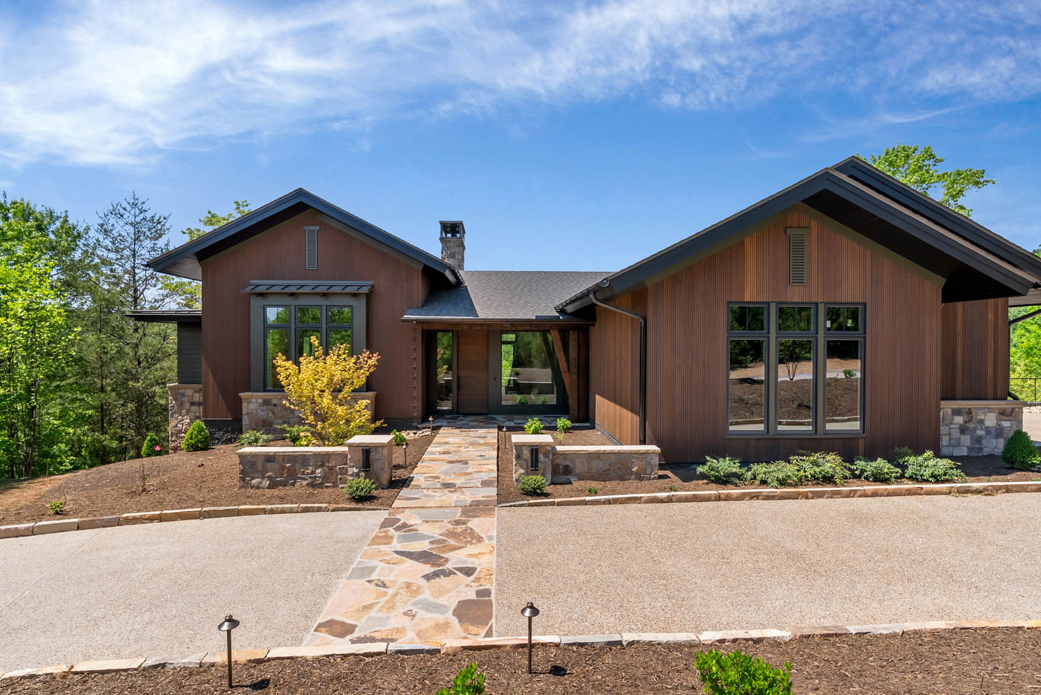 Front exterior of Casa Bonita 2 featuring custom triple-fluted thermally modified Southern Yellow Pine wood siding in AquaFir Cascade.