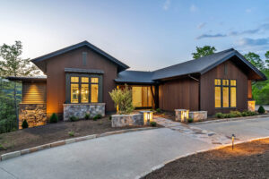 Front exterior of Casa Bonita 2 at dusk featuring custom triple-fluted thermally modified Southern Yellow Pine wood siding in AquaFir Cascade.