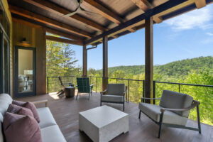 Covered outdoor balcony with Thermally Modified Southern Yellow Pine wood decking and timber posts overlooking North Carolina Mountains at Casa Bonita 2.