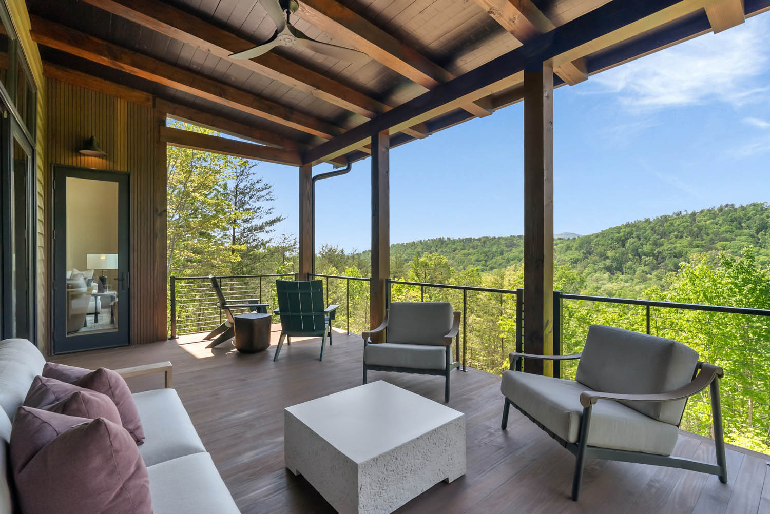 Covered outdoor balcony with Thermally Modified Southern Yellow Pine wood decking and timber posts overlooking North Carolina Mountains at Casa Bonita 2.